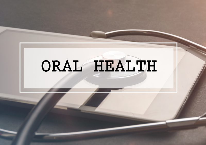 Medical Concept: Word written ORAL HEALTH with stethoscope and electronic tablet.Filter applied.