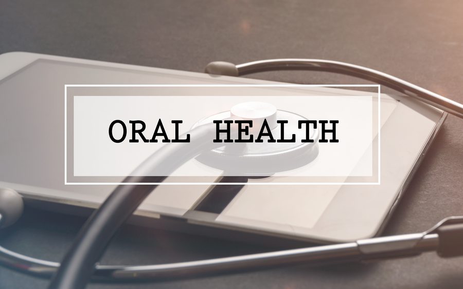 Medical Concept: Word written ORAL HEALTH with stethoscope and electronic tablet.Filter applied.