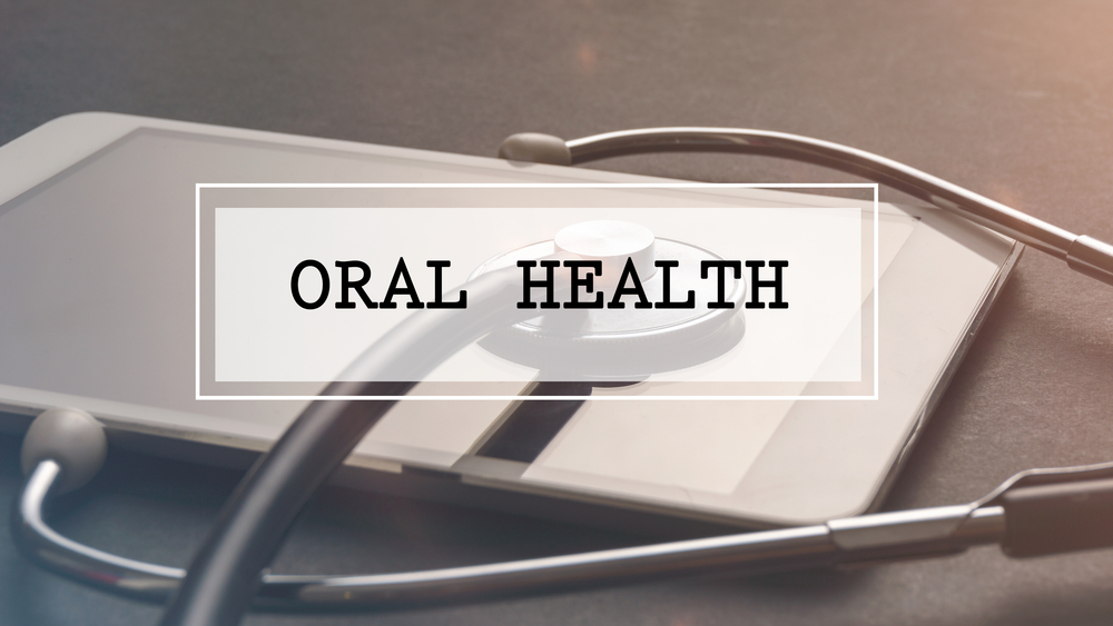 Medical Concept: Word written ORAL HEALTH with stethoscope and electronic tablet.Filter applied.